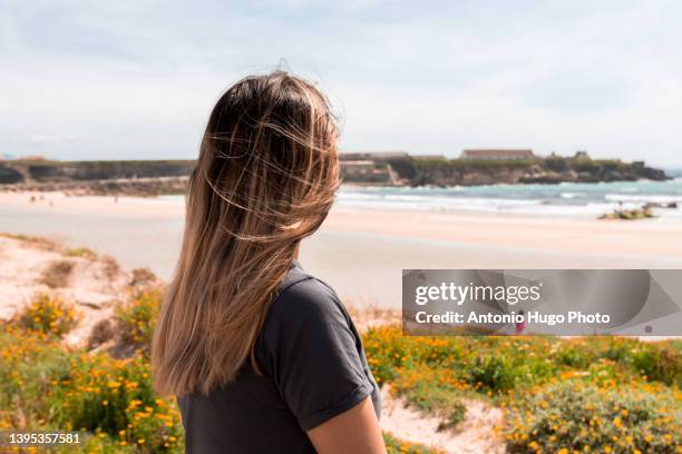 portrait of a woman looking to a beach. - tarifa moors stock pictures, royalty-free photos & images