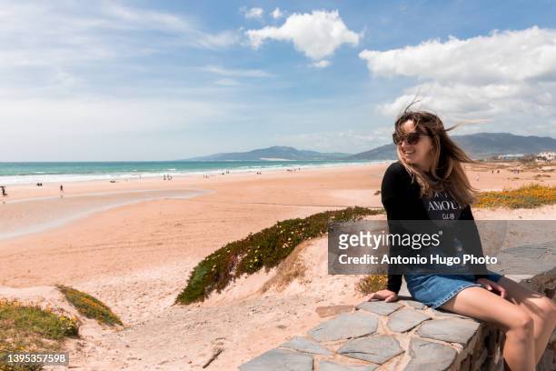 portrait of a woman with sunglasses relaxing on a beach. - tarifa moors stock pictures, royalty-free photos & images