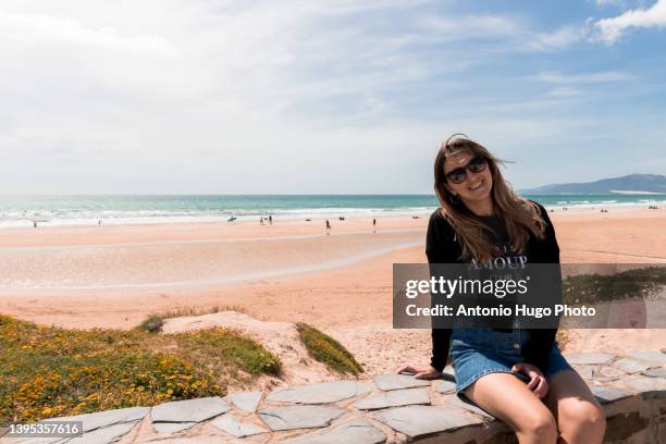 portrait of a woman with sunglasses relaxing on a beach. - tarifa moors stock pictures, royalty-free photos & images