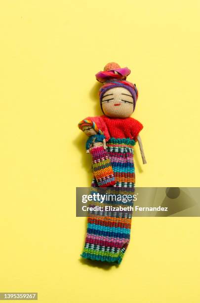 the worry doll (muñequita quitapenas in spanish) on yellow background - boneca de pano - fotografias e filmes do acervo