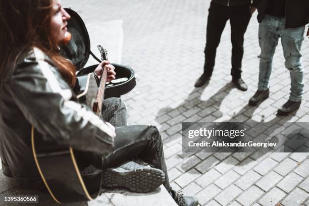 side view of guitarist playing songs for friends in park - street musician stock pictures, royalty-free photos & images