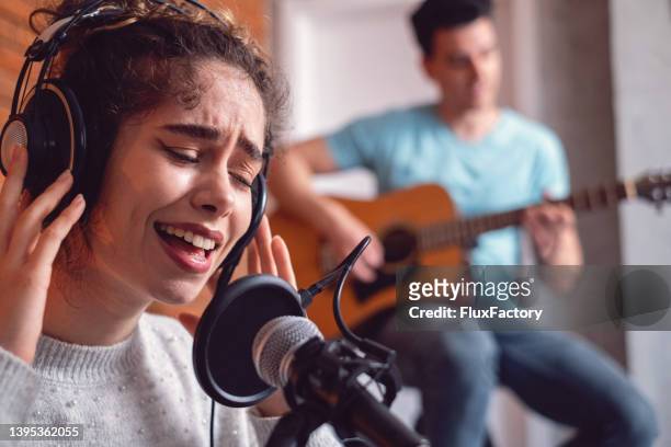 close up of female and male musicians having a rehearsal from modern home music studio - rehearsal imagens e fotografias de stock