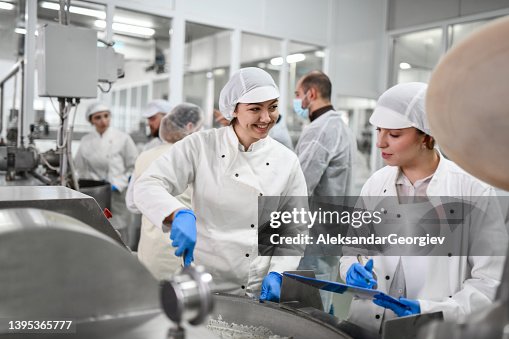 Smiling Female Workers Preparing Necessary Cottage Chees Mixture In Factory For Stuffed Peppers Smiling Female Workers Preparing Necessary Cottage Chees Mixture In Factory For Stuffed Peppers
