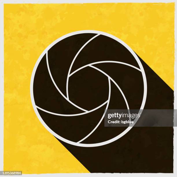 camera shutter. icon with long shadow on textured yellow background - double exposure tech stock illustrations