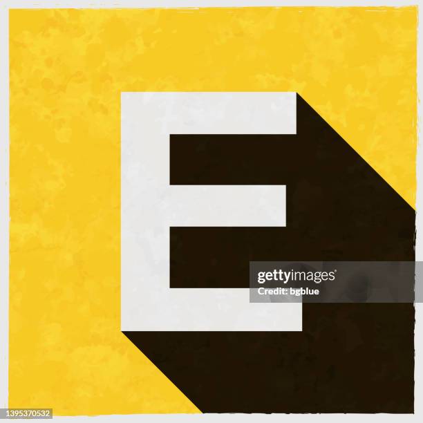 letter e. icon with long shadow on textured yellow background - e v logo stock illustrations