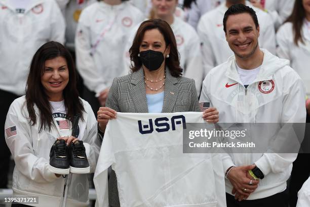 Vice President Kamala Harris is given a pair of shoes and a Team USA shirt by Paralympic Alpine Skier Danelle Umstead and Olympic Athlete Tyler...