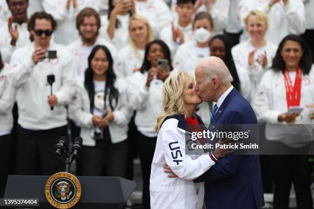 President Joe Biden and U.S. First lady Jill Biden kiss in front of members of Team USA on the South Lawn at the White House on May 04, 2022 in...