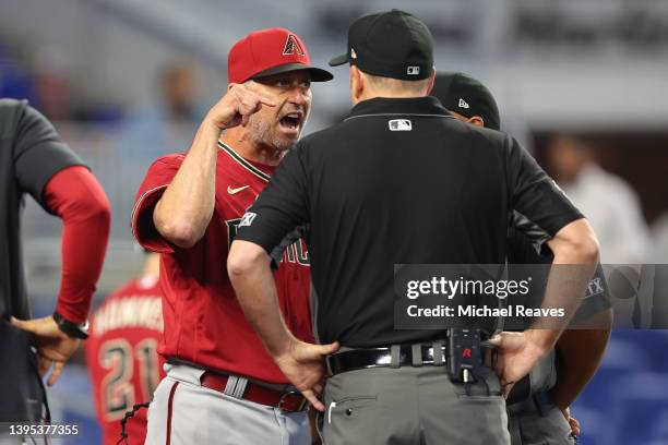 Manager Torey Lovullo of the Arizona Diamondbacks argues with umpires Dan Bellino and Adrian Johnson after Madison Bumgarner was ejected from the...