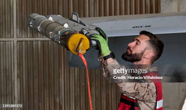 The armorer inspects the Sidewinder missile of a fully armed Spain's Air Force F-18 in the hangar between NATO patrols in Torrejon Air Base on May...