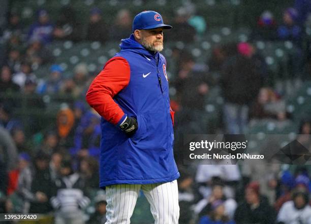 Manager David Ross of the Chicago Cubs walks to the dugout following a pitching change during a game against the Chicago White Sox at Wrigley Field...