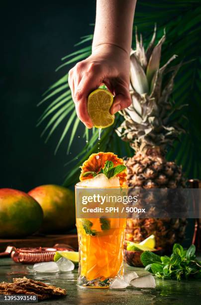 cropped hand of woman holding drink on table - barman tequila stock-fotos und bilder