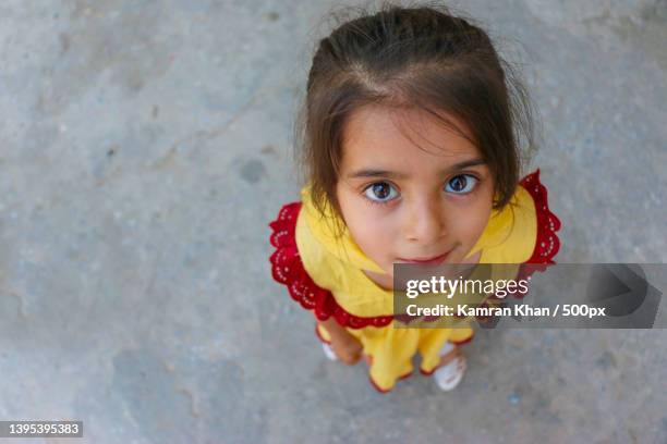 high angle portrait of cute girl standing on road,swat,khyber pakhtunkhwa,pakistan - pakistan people stock pictures, royalty-free photos & images