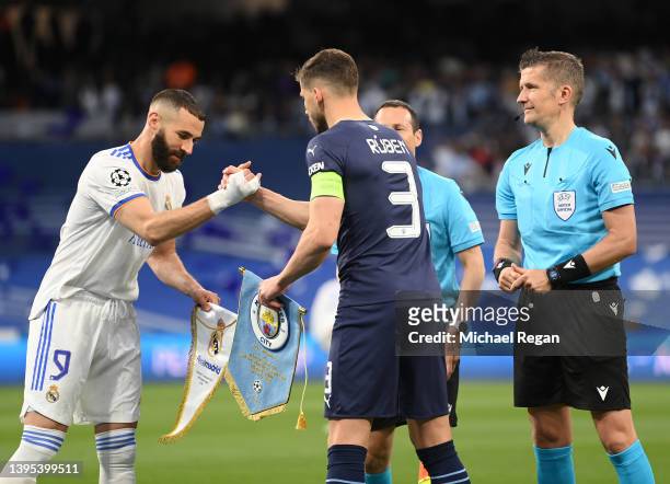 Karim Benzema of Real Madrid and Ruben Dias of Manchester City shake hands as they swap match pennants prior to the UEFA Champions League Semi Final...