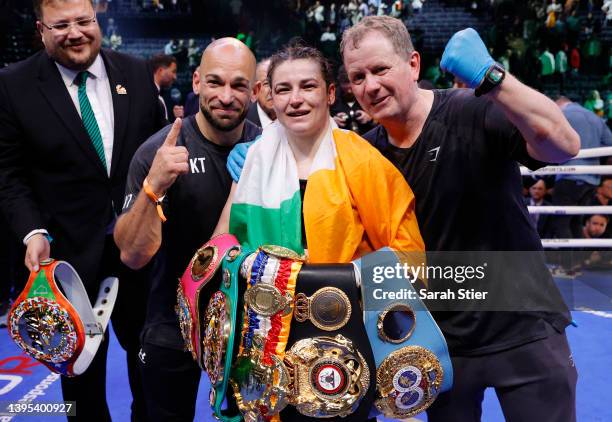 Katie Taylor of Ireland poses with her team after defeating Amanda Serrano of Puerto Rico for the World Lightweight Title fight at Madison Square...