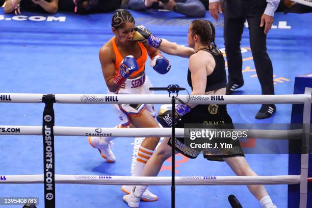 Katie Taylor of Ireland hits Amanda Serrano of Puerto Rico during their world lightweight championship fight. Taylor would win by split decision to...