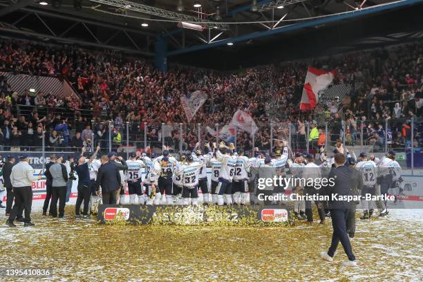 Team of Eisbaeren Berlin celebrates with trophy in front of their fans after winning the DEL Playoff Final Game 4 between EHC Red Bull Muenchen and...