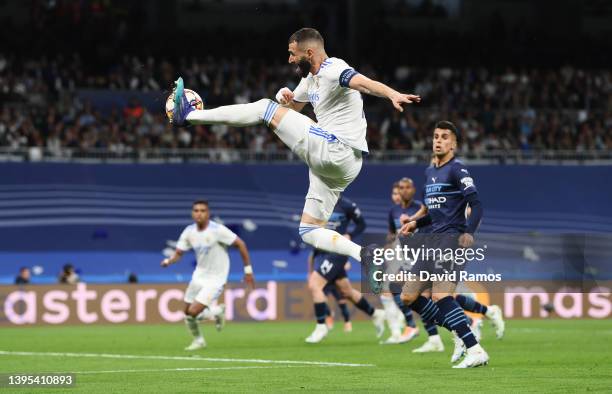 Karim Benzema of Real Madrid makes a pass before Rodrygo of Real Madrid scores their side's first goal during the UEFA Champions League Semi Final...