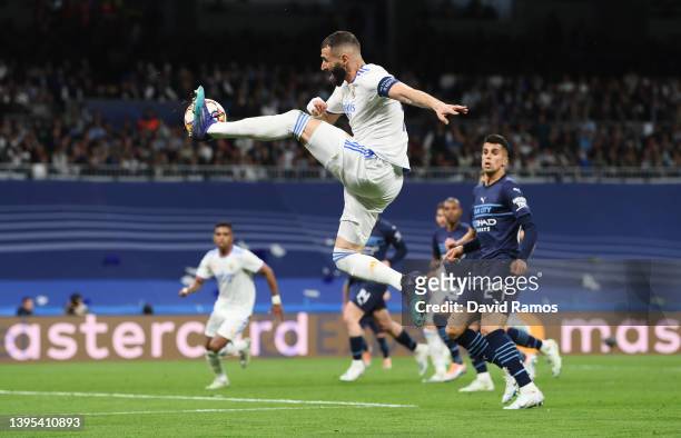 Karim Benzema of Real Madrid makes a pass before Rodrygo of Real Madrid scores their side's first goal during the UEFA Champions League Semi Final...