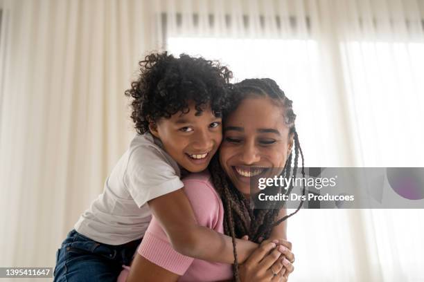 happy mother and son on mother's day - real people family portraits stockfoto's en -beelden