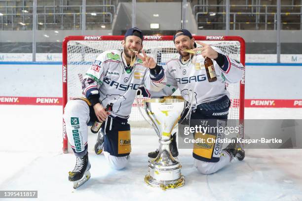 Zach Boychun of Eisbaeren Berlin and Matthew White of Eisbaeren Berlin celebrate with traophy after winning the DEL Playoff Final Game 4 between EHC...