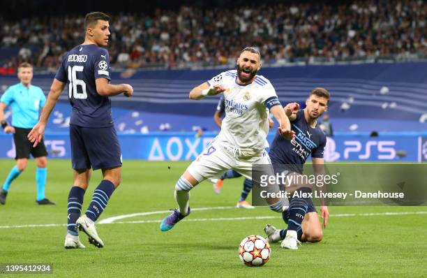 Karim Benzema of Real Madrid is fouled by Ruben Dias of Manchester City for a penalty during the UEFA Champions League Semi Final Leg Two match...