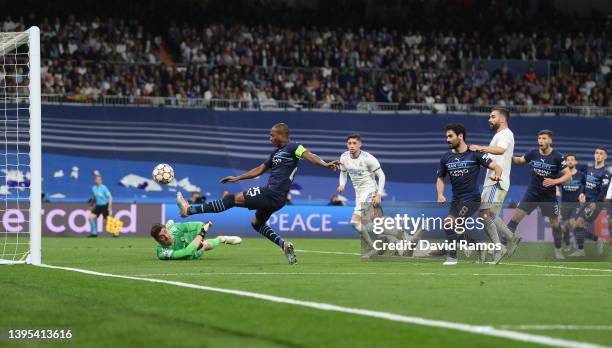 Fernandinho of Manchester City misses a shot whilst under pressure from Thibaut Courtois of Real Madrid during the UEFA Champions League Semi Final...