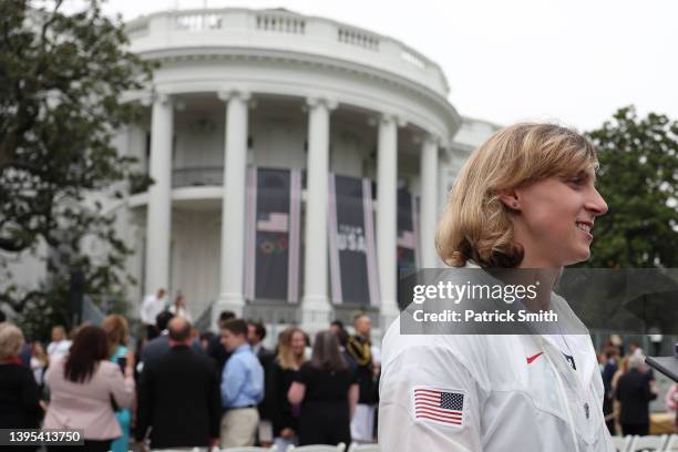 Member of Team USA and Olympic Gold Medalist swimmer Katie Ledecky looks on as she is interviewed by reporters at the White House on May 04, 2022 in...