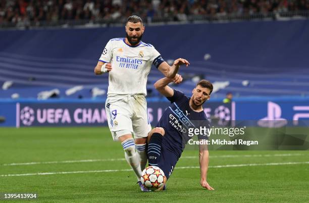 Karim Benzema of Real Madrid is fouled by Ruben Dias of Manchester City leading to a penalty being awarded during the UEFA Champions League Semi...