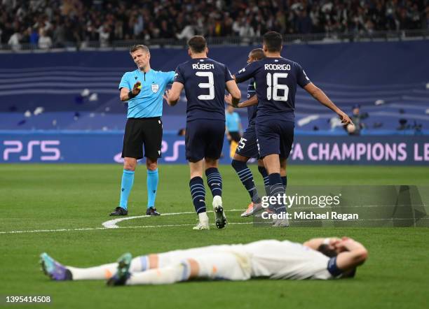Match Referee, Daniele Orsato points for a penalty to Real Madrid as Ruben Dias and Rodrigo of Manchester City protest during the UEFA Champions...