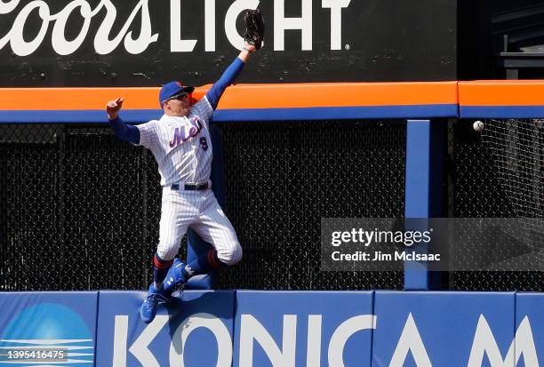 Brandon Nimmo of the New York Mets can't come up with a ball hit in the eighth inning by Guillermo Heredia of the Atlanta Braves for a two run home...