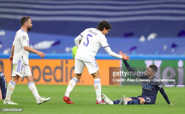 Jesus Vallejo of Real Madrid shakes hands with Phil Foden of Manchester City after the UEFA Champions League Semi Final Leg Two match between Real...