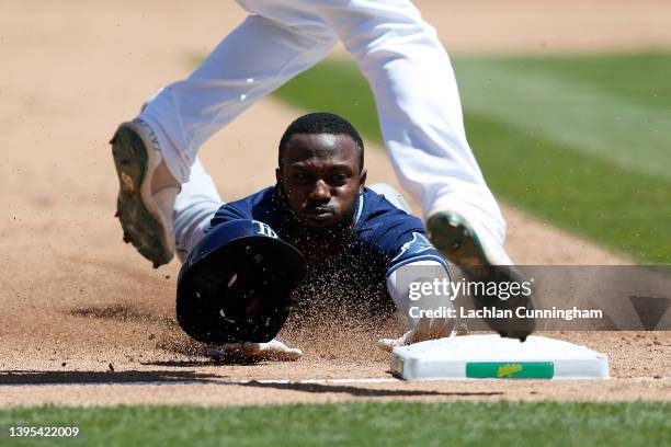 Randy Arozarena of the Tampa Bay Rays steals third base in the top of the sixth inning against the Oakland Athletics at RingCentral Coliseum on May...