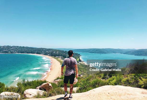 rear view of man standing from the top of barrenjoey lighthouse with views of palm beach - sydney stock-fotos und bilder