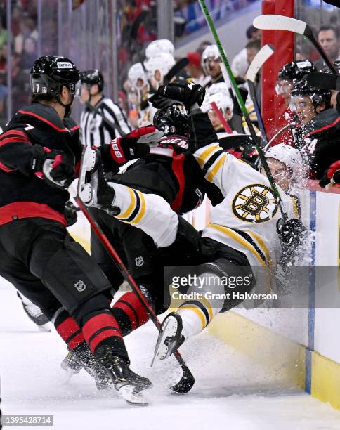 Jesperi Kotkaniemi of the Carolina Hurricanes checks Curtis Lazar of the Boston Bruins during the first period of Game Two of the First Round of the...