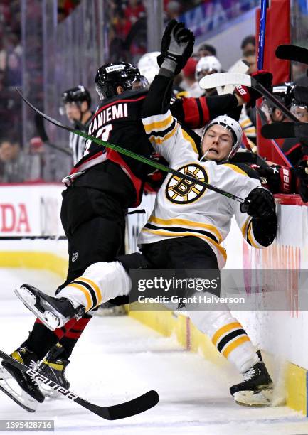 Jesperi Kotkaniemi of the Carolina Hurricanes checks Curtis Lazar of the Boston Bruins during the first period of Game Two of the First Round of the...