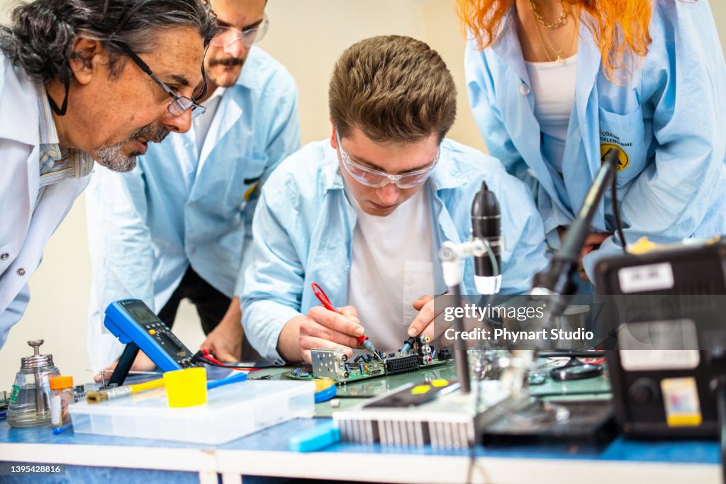 Group of young people in technical vocational training with teacher