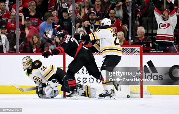 Nino Niederreiter celebrates as teammate Jesper Fast of the Carolina Hurricanes scores against Linus Ullmark of the Boston Bruins during the first...