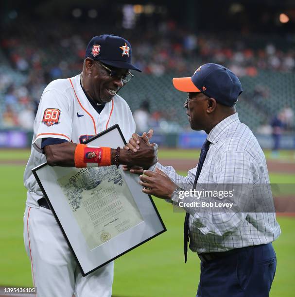 Mayor Sylvester Turner, right, shakes hands with Dusty Baker Jr. #12 of the Houston Astros as he is presented a proclamation naming May 3 Dusty Baker...