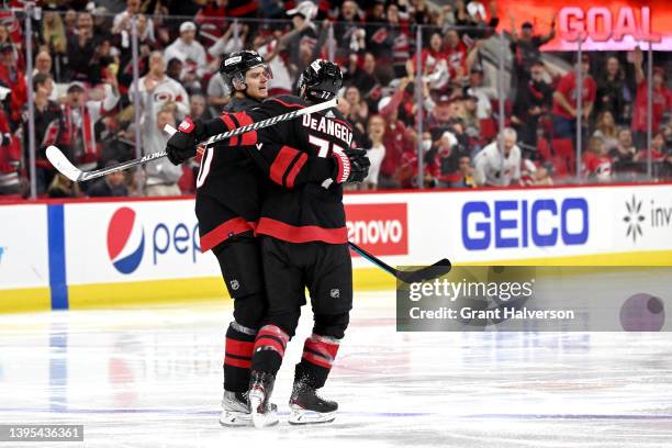 Sebastian Aho celebrates with teammate Tony DeAngelo of the Carolina Hurricanes after scoring a goal against the Boston Bruins during the second...