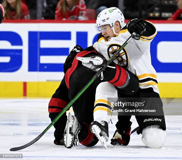 Curtis Lazar of the Boston Bruins tangles with Brady Skjei of the Carolina Hurricanes during the second period of Game Two of the First Round of the...