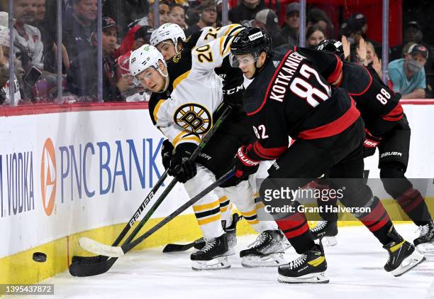Curtis Lazar of the Boston Bruins and Jesperi Kotkaniemi of the Carolina Hurricanes battle for the puck during the second period of Game Two of the...