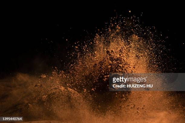 cocoa powder explosion in motion - polvo de cacao fotografías e imágenes de stock