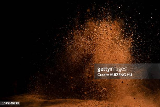 cocoa powder explosion in motion - powder explosion photos et images de collection