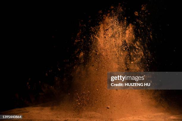 cocoa powder explosion in motion - chocolate explosion stock pictures, royalty-free photos & images