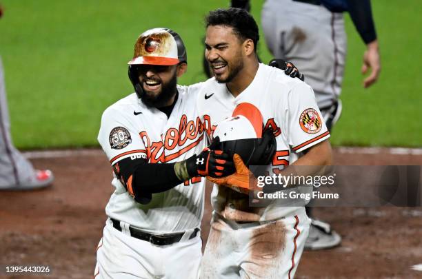 Anthony Santander of the Baltimore Orioles celebrates with Rougned Odor after scoring in the fourth inning against the Minnesota Twins at Oriole Park...