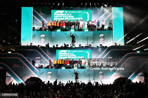 The F1 drivers throw out gifts to the crowd from the stage during the F1 Grand Prix of Miami Opening Party at Hard Rock Stadium on May 04, 2022 in...