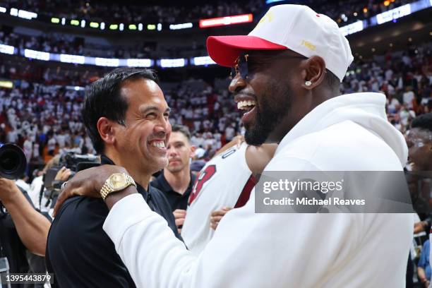 Head coach Erik Spoelstra of the Miami Heat greets former Miami Heat player Dwyane Wade after Game Two of the Eastern Conference Semifinals against...