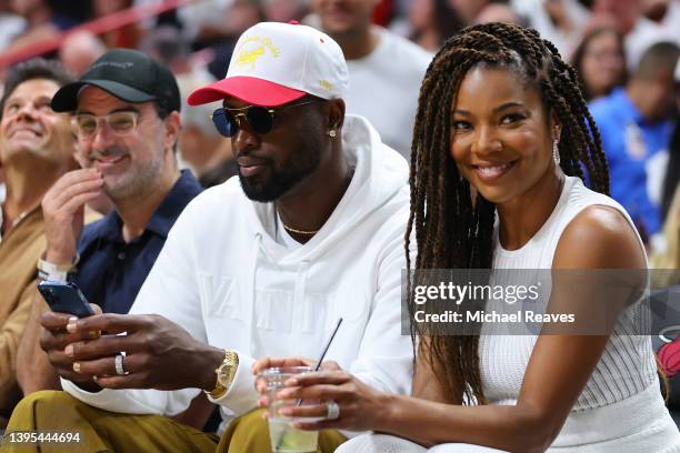 Former Miami Heat player Dwyane Wade and his wife, Gabrielle Union, look on courtside during the second half in Game Two of the Eastern Conference...