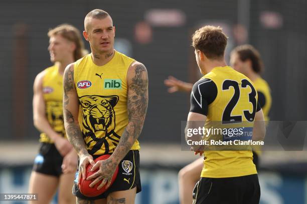 Dustin Martin of the Tigers speaks to Kane Lambert during a Richmond Tigers AFL training session at Punt Road Oval on May 05, 2022 in Melbourne,...