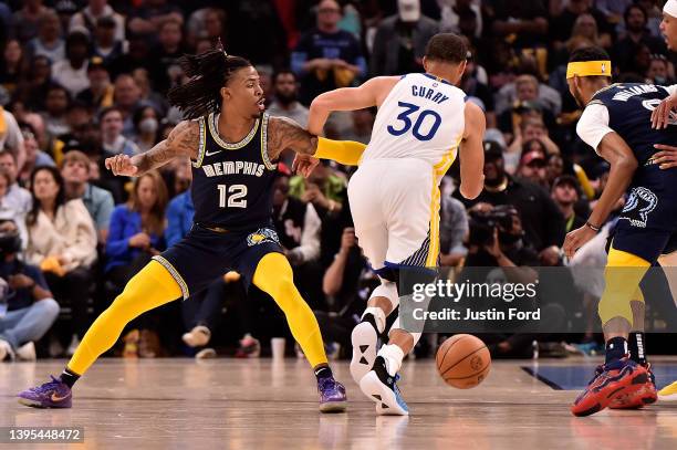 Stephen Curry of the Golden State Warriors goes to the basket against Ja Morant of the Memphis Grizzlies during Game Two of the Western Conference...